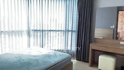 Bright bedroom with large windows and modern furniture