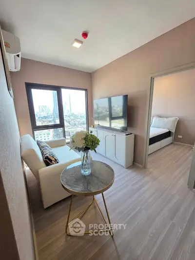 Modern living room with city view, featuring sleek furniture and stylish decor in a high-rise apartment.