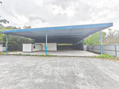 Spacious industrial warehouse with open layout and ample parking space.