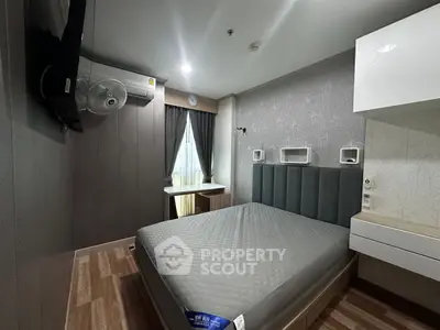 Modern bedroom with stylish decor and natural light, featuring a comfortable bed and sleek furnishings.