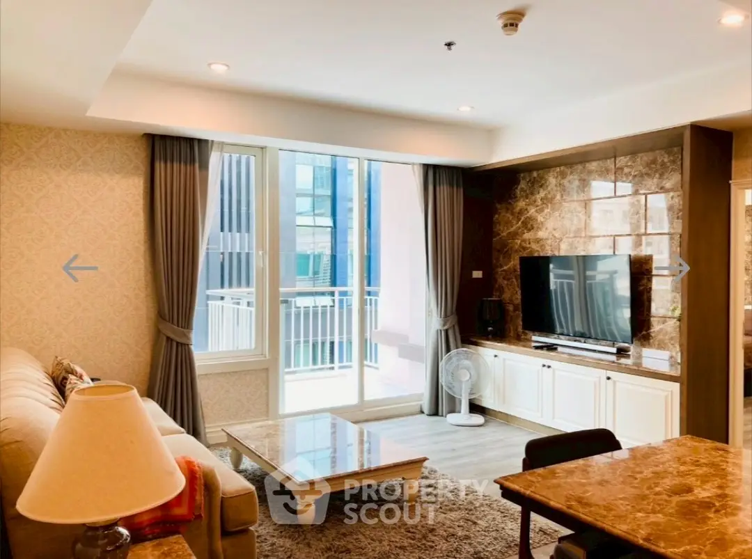 Spacious living room with modern decor and large windows offering natural light.