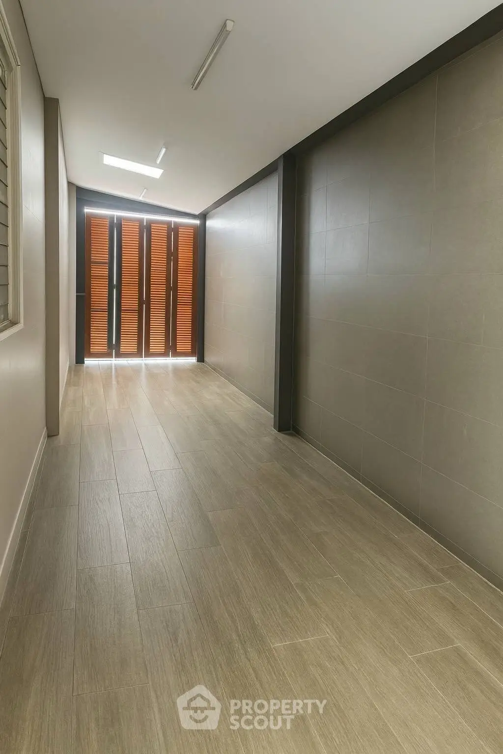 Spacious hallway with modern wooden flooring and natural light