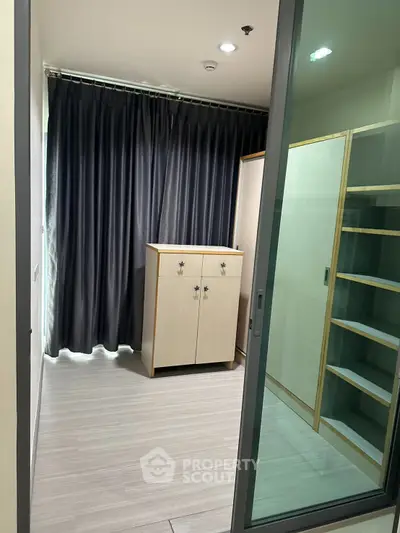 Spacious storage room with modern cabinetry and sliding glass door