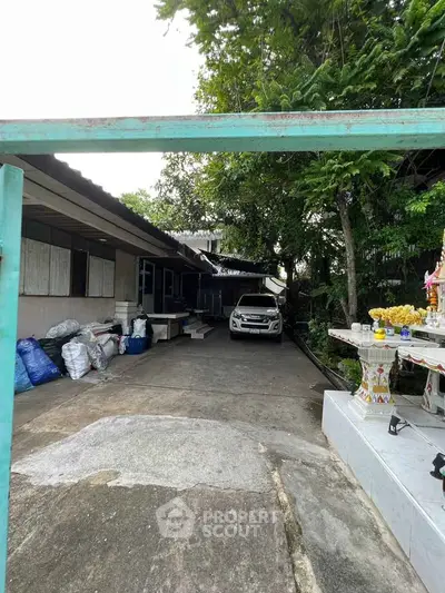 Charming residential property with spacious driveway and lush greenery.