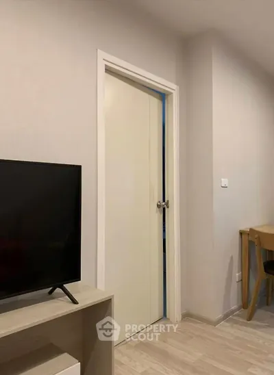 Modern living room with sleek TV stand and wooden furniture, perfect for cozy evenings.