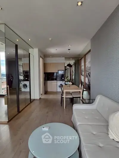 Modern living room with sleek furniture and mirrored walls in a stylish apartment