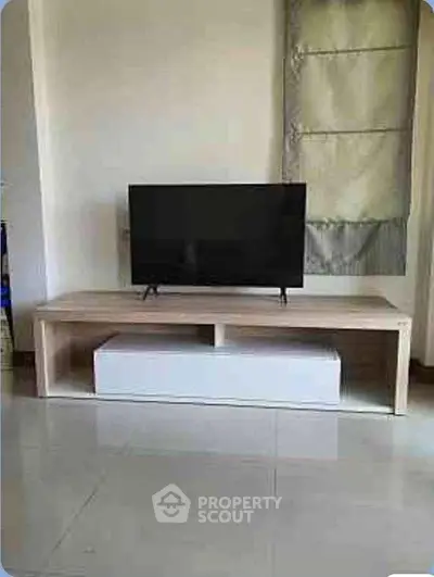 Modern living room with sleek TV stand and flat-screen television