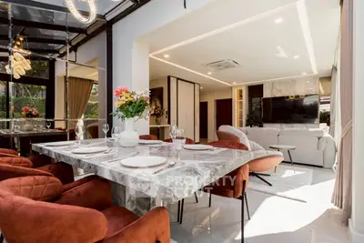 Luxurious open-plan living and dining area with elegant decor and modern furnishings.