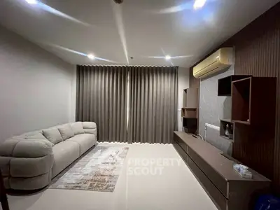 Modern living room with sleek furniture and elegant curtains, featuring a cozy sofa and wall-mounted air conditioner.