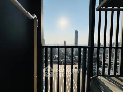 Stunning city view from a modern balcony with sleek railing design.