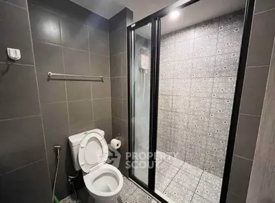Modern bathroom with sleek tiles and glass shower enclosure