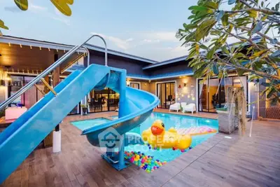 Luxurious modern villa with private pool, slide, and vibrant outdoor decor for ultimate relaxation and entertainment.