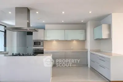 Modern kitchen with sleek cabinetry and gas stove in luxury apartment