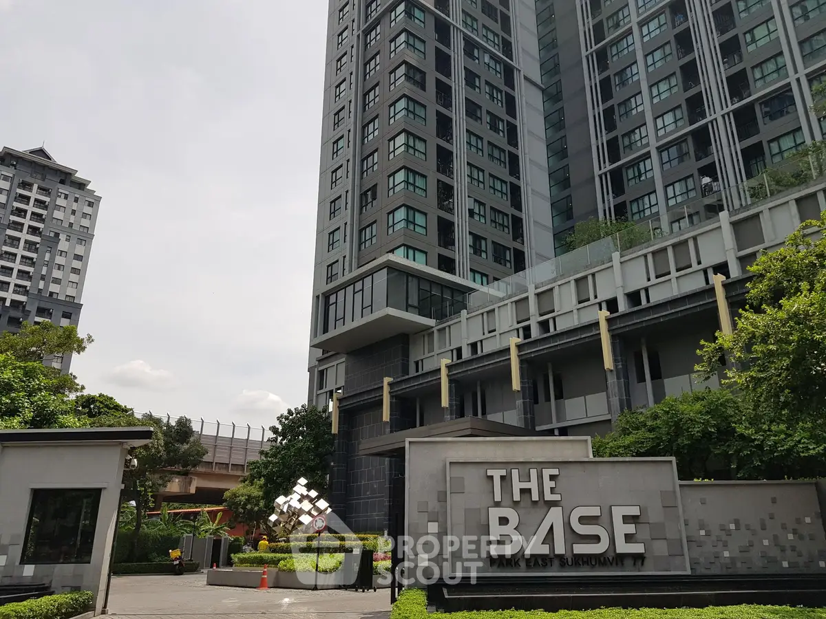 Modern high-rise building with lush greenery at The Base Park East Sukhumvit.