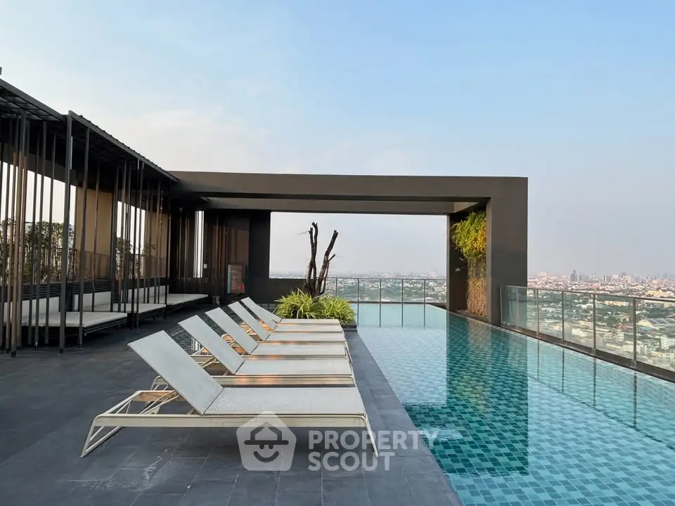 Luxurious rooftop pool with stunning city views and modern lounge chairs.