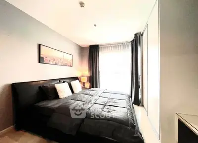Modern bedroom with stylish decor and ample natural light