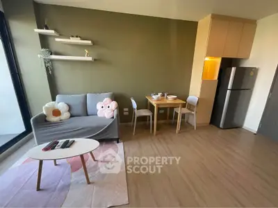 Modern living room with stylish decor and open layout, featuring a cozy sofa and dining area.