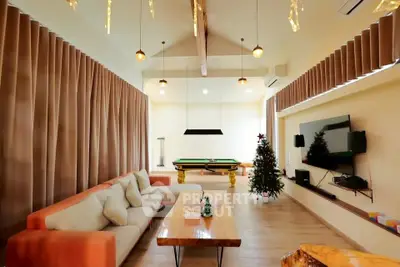 Spacious living room with modern decor and pool table, perfect for entertainment.