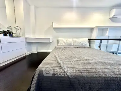 Modern bedroom with sleek design and cozy ambiance, featuring a comfortable bed and stylish decor.