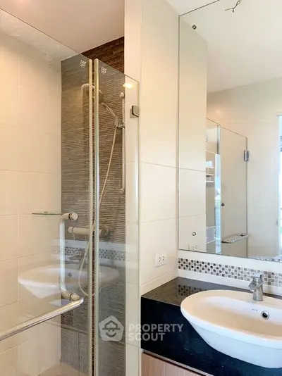 Modern bathroom with glass shower and sleek sink design