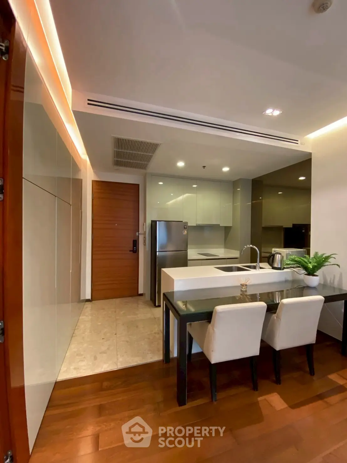 Modern kitchen with sleek design and dining area in luxury apartment