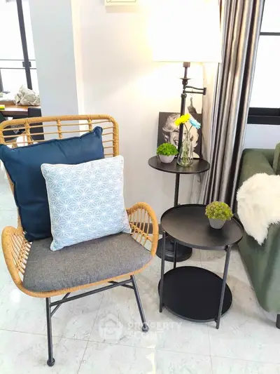 Chic living room corner with stylish wicker chair, cozy cushions, and elegant side table with decor accents.