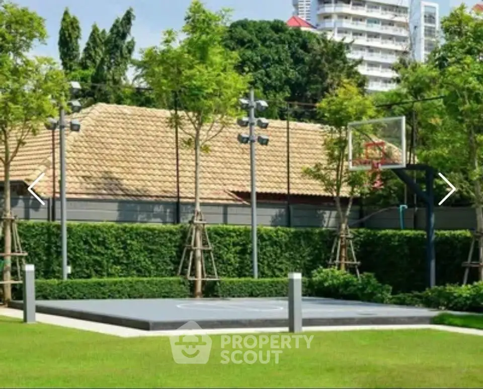Luxurious outdoor basketball court in lush garden setting, perfect for sports enthusiasts.