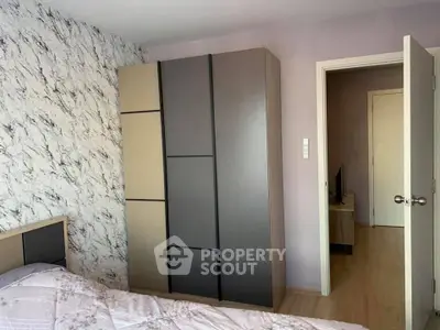 Modern bedroom with stylish wardrobe and marble accent wall.