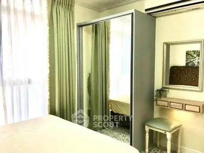 Cozy bedroom with mirrored wardrobe and elegant green curtains