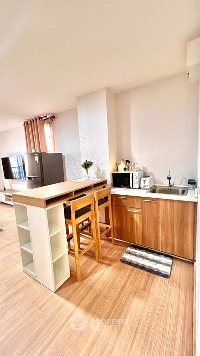 Modern kitchen with wooden cabinets and breakfast bar in open layout apartment