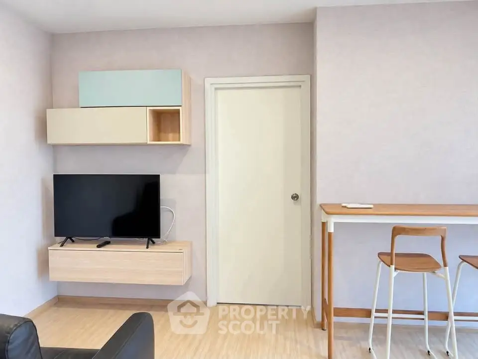 Modern living room with wall-mounted TV and minimalist furniture