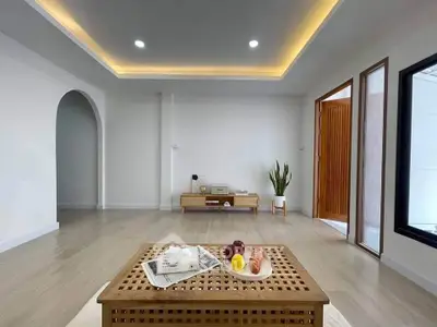 Spacious modern living room with elegant lighting and wooden accents