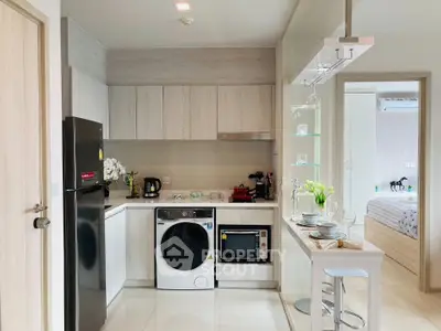 Modern kitchen with sleek appliances and breakfast bar in stylish apartment