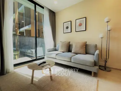 Modern living room with cozy sofa and natural light in stylish apartment.