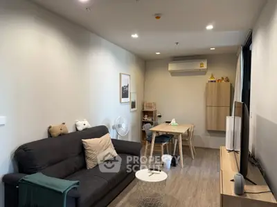 Modern living room with cozy sofa, dining area, and stylish decor