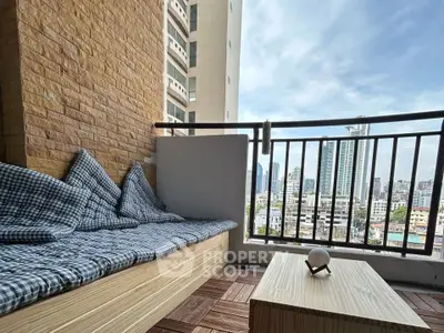 Charming balcony with cozy seating and city view, perfect for relaxation and enjoying the skyline.