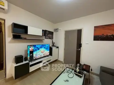 Modern living room with sleek furniture and wall-mounted TV, perfect for cozy evenings.