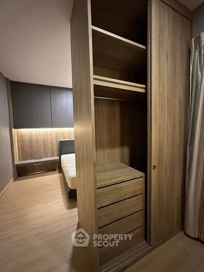 Modern bedroom with built-in wooden wardrobe and cozy lighting