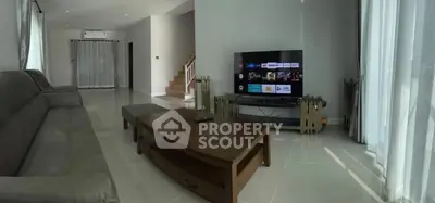 Spacious living room with modern TV setup and elegant furniture