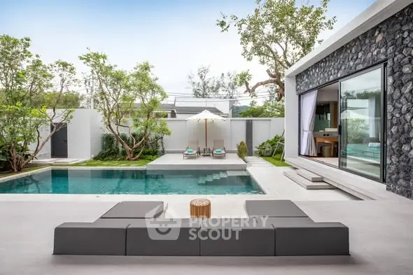 Luxurious modern villa with private pool and stylish outdoor seating area.