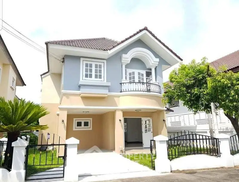 Charming two-story house with elegant facade and lush greenery in suburban neighborhood.