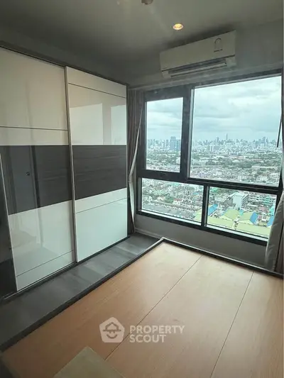 Modern bedroom with panoramic city view and sleek wardrobe design.
