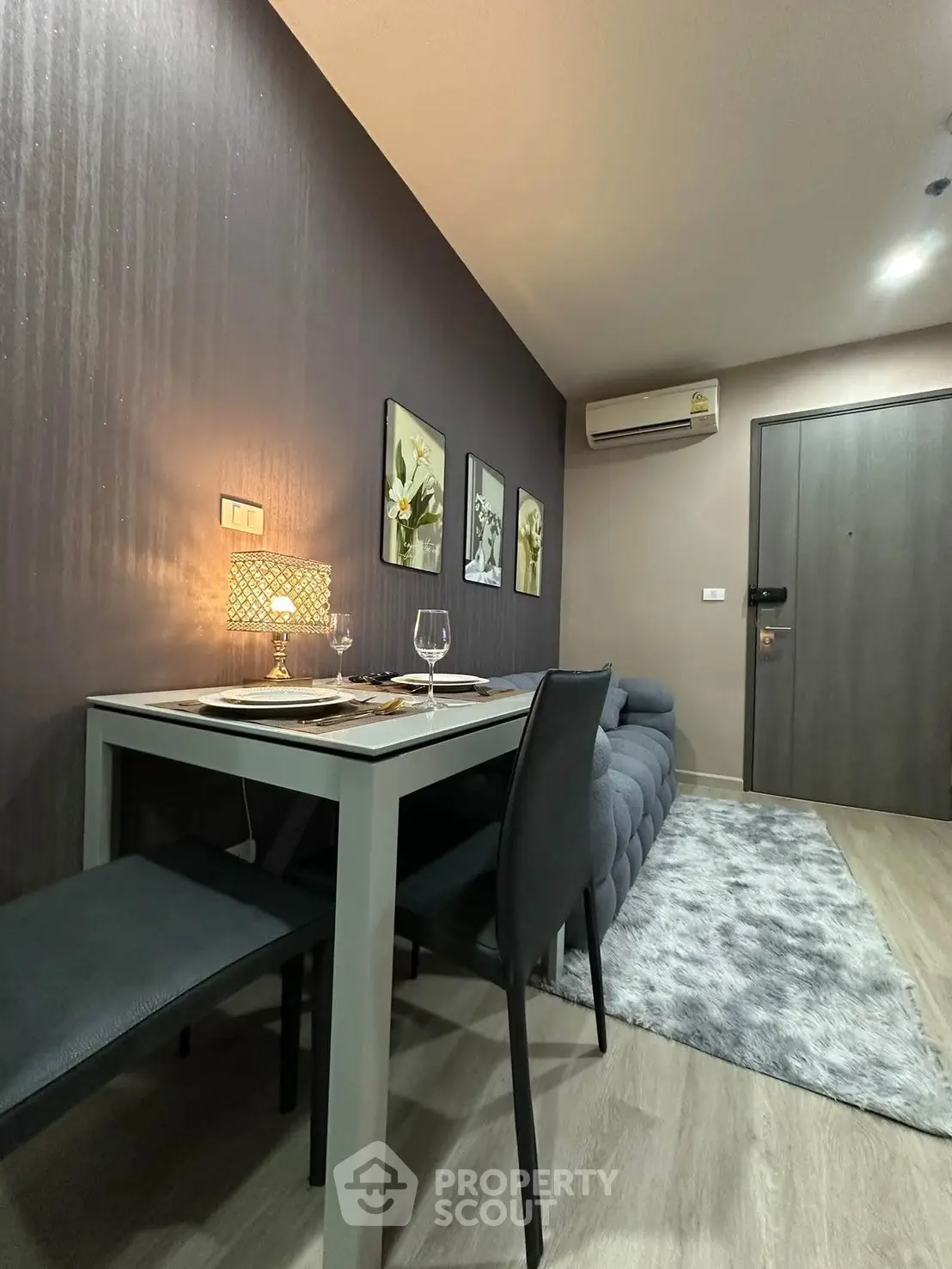 Modern dining area with stylish decor and cozy ambiance in a contemporary apartment.
