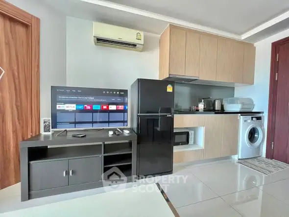 Modern living room with sleek appliances and stylish furniture in a contemporary apartment.
