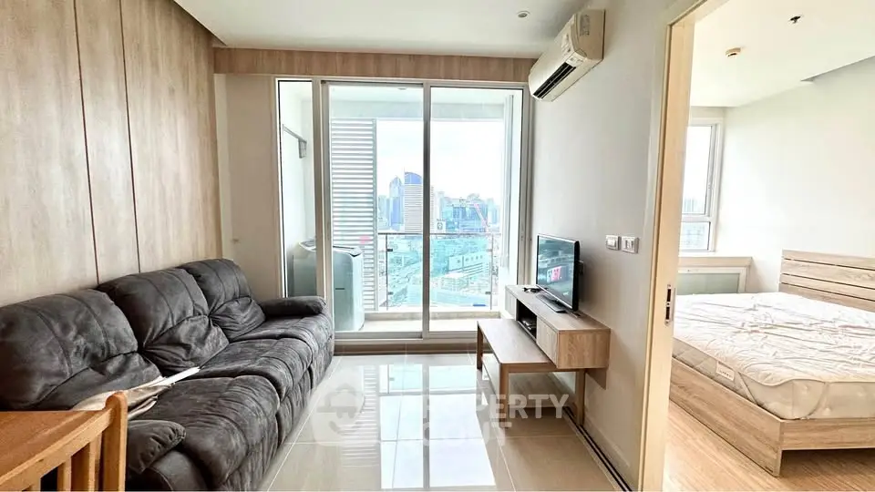 Modern living room with city view and cozy bedroom in urban apartment