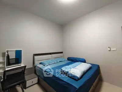 Cozy bedroom with modern furnishings and blue bedding, ideal for restful nights.