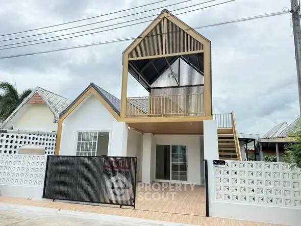 Modern two-story house with unique architectural design and spacious balcony.