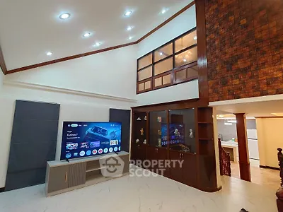 Spacious living room with high ceiling and modern decor