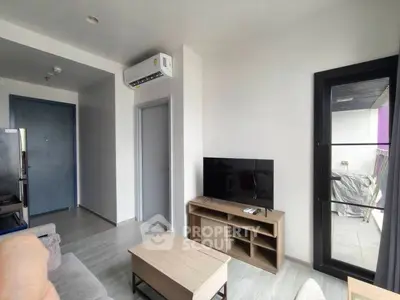 Modern living room with sleek furniture and balcony access