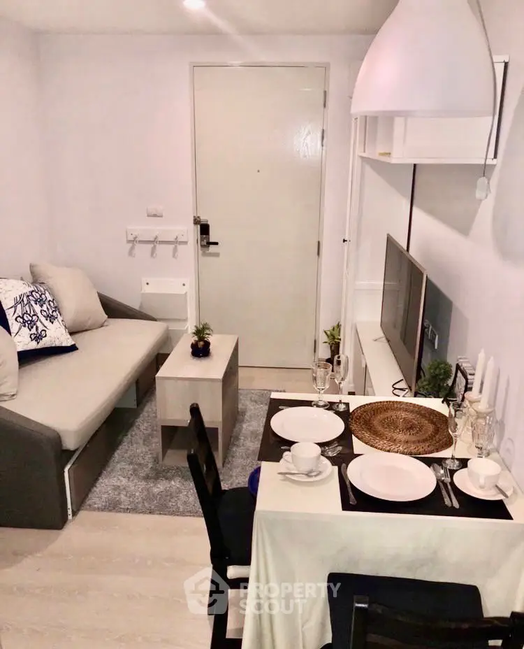 Cozy living room with modern decor and dining area in compact apartment